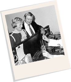 polaroid of a couple looking at a test tube