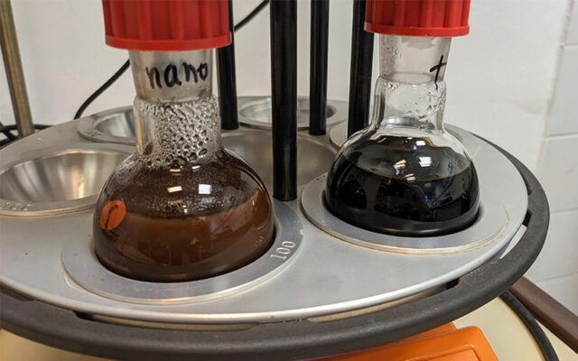 Carousel 6 being used in sustainalbe research to extract beta carotene from yeast waste. The liquid in the flasks is a dark brown.